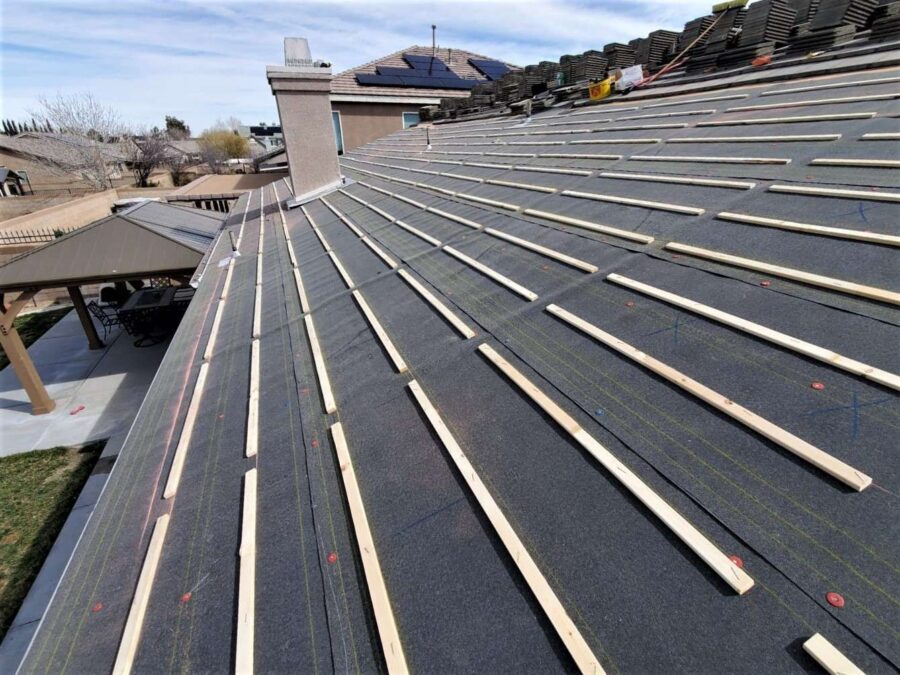 Wood batten strips installed over felt paper underlayment in Lancaster, CA—roof prepped for tile reinstallation and solar integration