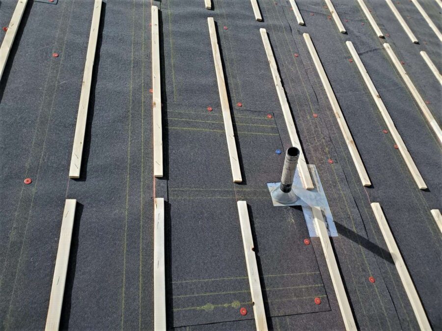Wood batten strips installed over felt paper underlayment in Lancaster, CA—roof prepped for tile reinstallation and solar integration