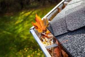Rain gutter debris cleanout on residential roof in Santa Clarita, CA – expert roofing maintenance by Coronado Roof Care