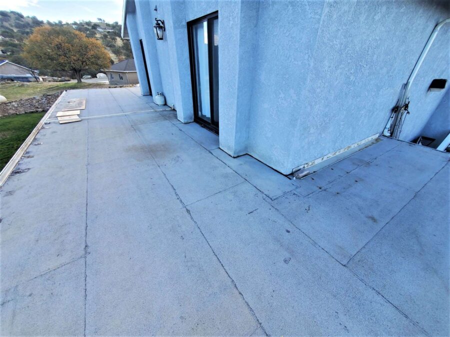 Second-story balcony in Tehachapi before second-layer modified bitumen installation—worn surface awaiting upgraded waterproofing