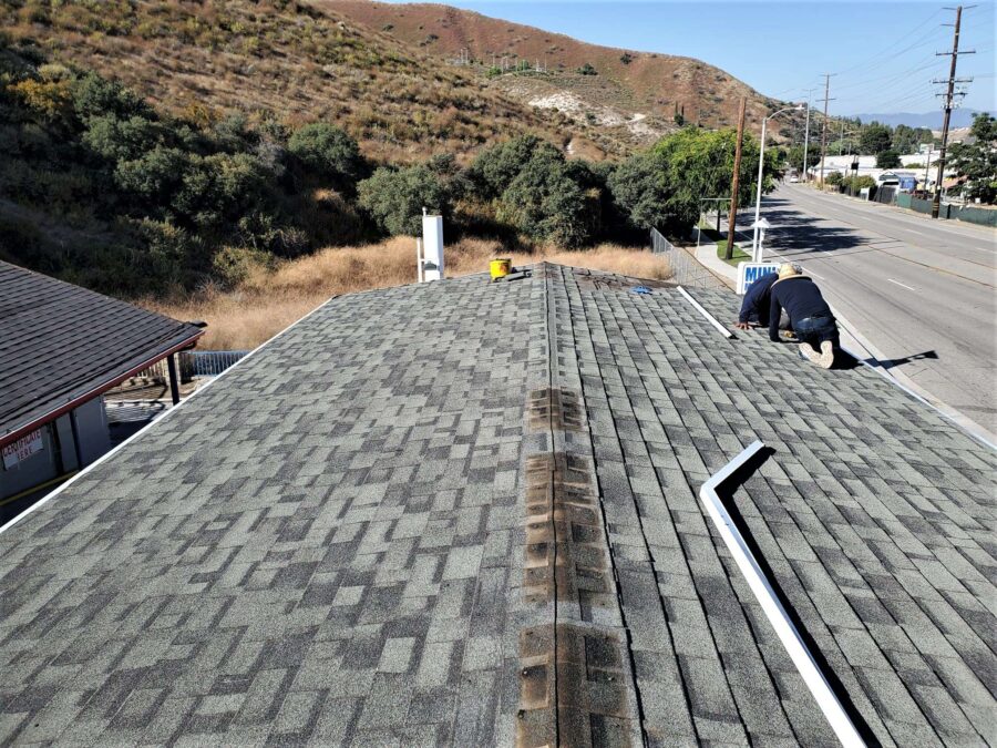 Gas station space frame in Canyon Country before second-layer Moonlit Black Malarkey shingle installation—roof prep phase