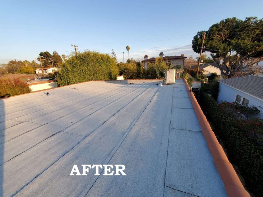 Completed second-layer modified bitumen roof with silicone sealant applied beneath existing solar panels in Los Angeles, CA