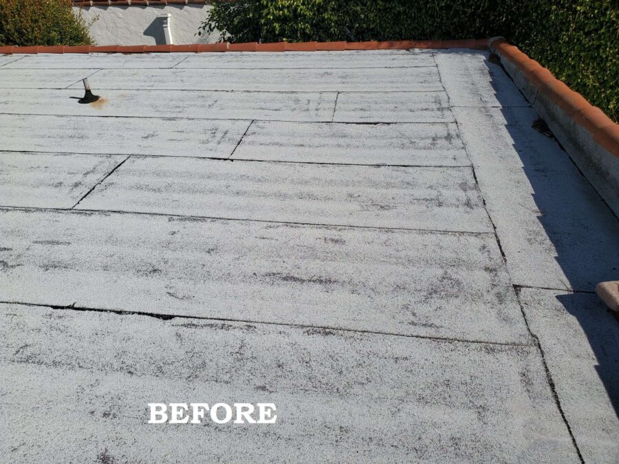 Flat roof in Los Angeles before second-layer modified bitumen and silicone sealing beneath solar panels—showing worn surface and prep stage