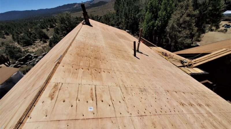 New plywood sheathing installed during new roof installation in Kennedy Meadows, CA—solid decking prep for Malarkey Willow Wood shingles