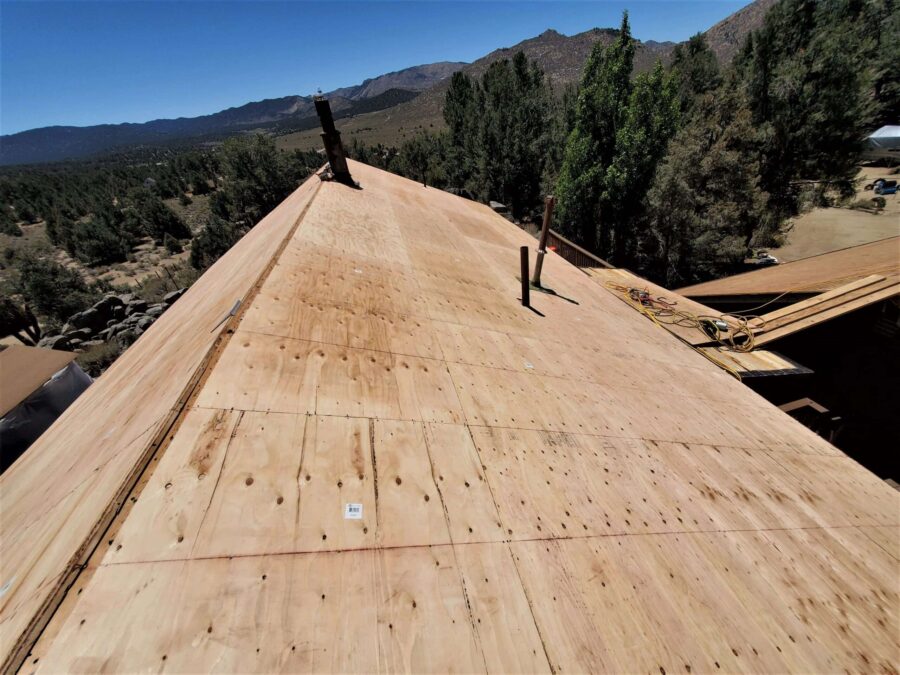 New plywood sheathing installed during new roof installation in Kennedy Meadows, CA—solid decking prep for Malarkey Willow Wood shingles