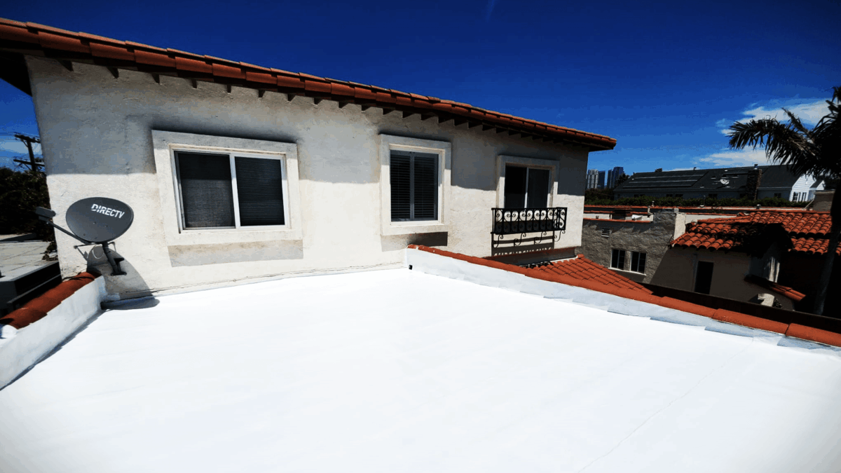 Flat-white modified bitumen cool roof on Spanish-style home in Los Angeles—reflective surface improves energy efficiency and reduces heat gain