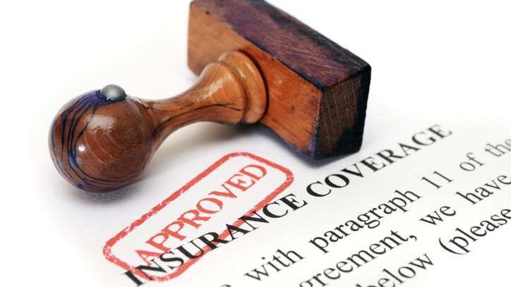 Home insurance approval stamp on roof claim paperwork—symbolizing successful roof replacement coverage approval