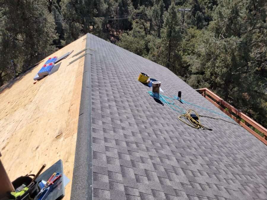 Partially installed GAF Timberline shingles over Palisade synthetic underlayment and plywood during roof replacement in Pine Mountain Club, CA