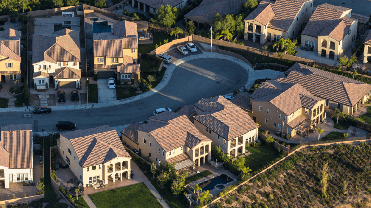 Aerial view of San Fernando Valley cul-de-sac with tile-roofed homes—highlighting maintenance needs for clustered residential roofs