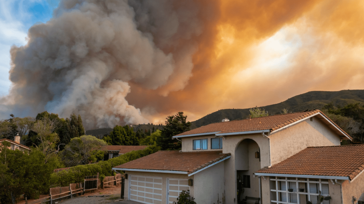 California wildfire sparked by dry lightning sends smoke and flames near home with a concrete tile roof, highlighting fire danger